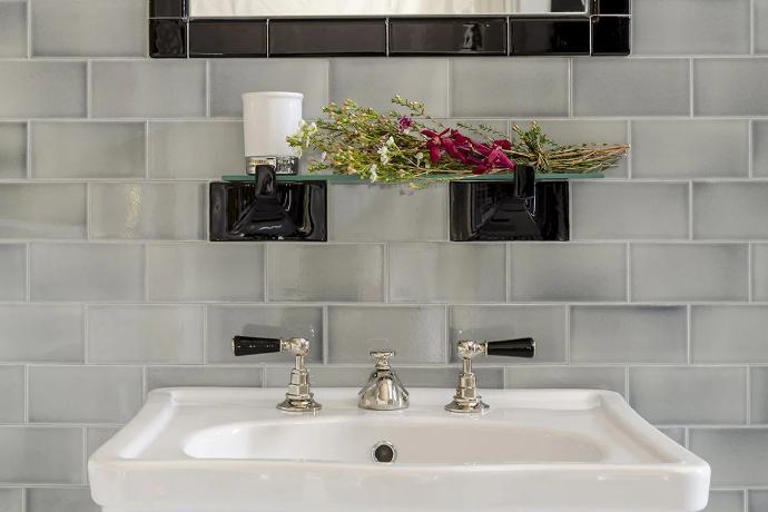 grey subway tile on wall in bathroom