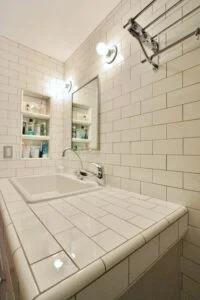 white subway tile on counter and wall in bathroom